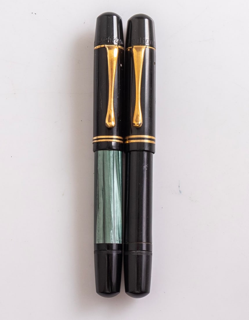 Pelikan 100N Fountain Pens: Lot of 2 Pelikan 100N fountain pens. Size: 4.8" (12.2 cm). 14K gold nibs, F/B. Very good external condition, unknown working order.