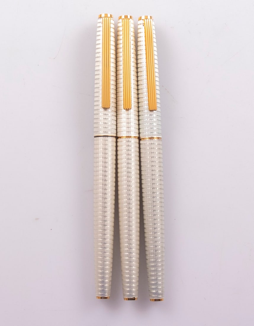 Pilot Deluxe Fountain Pens: Lot of 3 Pilot Deluxe fountain pen. Metal body and cap with Guilloche work. Section in blue, Jewels in blue. Size: 5.2" (13.2 cm). 14K/18K gold nibs, F. Mint, NOS.