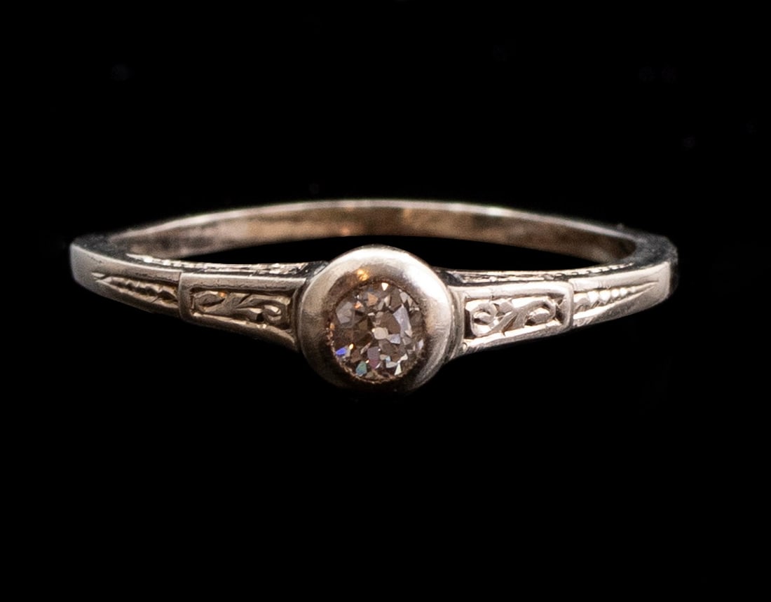 Gold Diamond Ring: 14K gold ring set with an old-cut diamond weighing about 15 points. Size: 3/4 7 US, Weight: 2.2 grams. Unmarked, gold tested.
