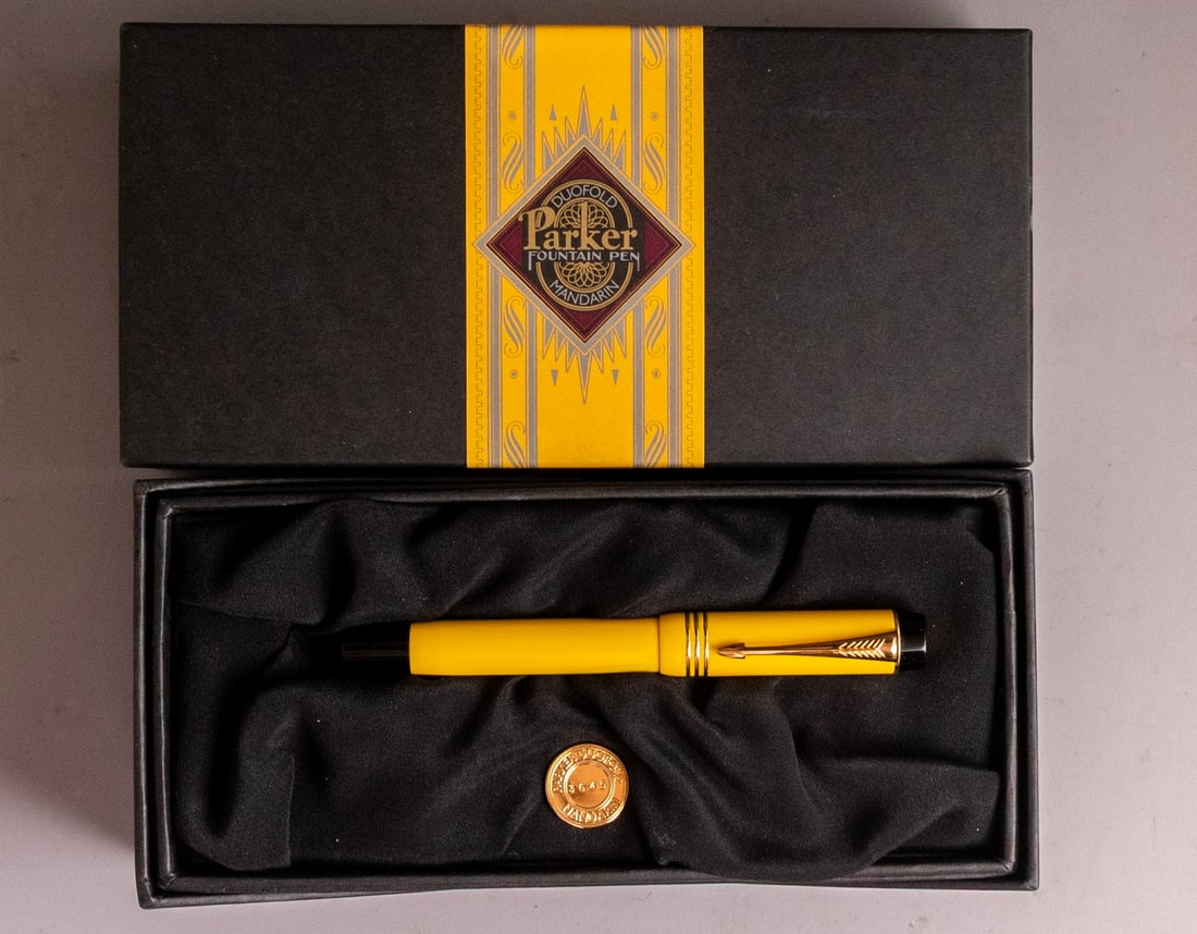 Parker Duofold Fountain Pen, Mandarin yellow, Numbered Edition: Parker Duofold fountain pen, Mandarin yellow, limited and numbered edition 3645/10000. Size: 5 3/8" (13.6 cm). 18K gold nib, M. Excellent condition, In original case with certificates.