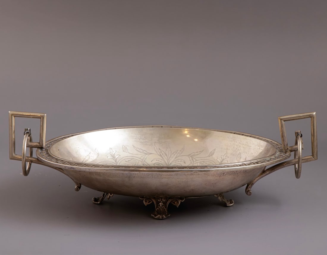 Austrian Silver Bowl: Austrian 800 silver bowl, decorated with openwork and engraving. Stands on four legs. With two handles. Length: 32 cm. Weight: 358 grams. Hallmarked. Minor flaws and old repairs.