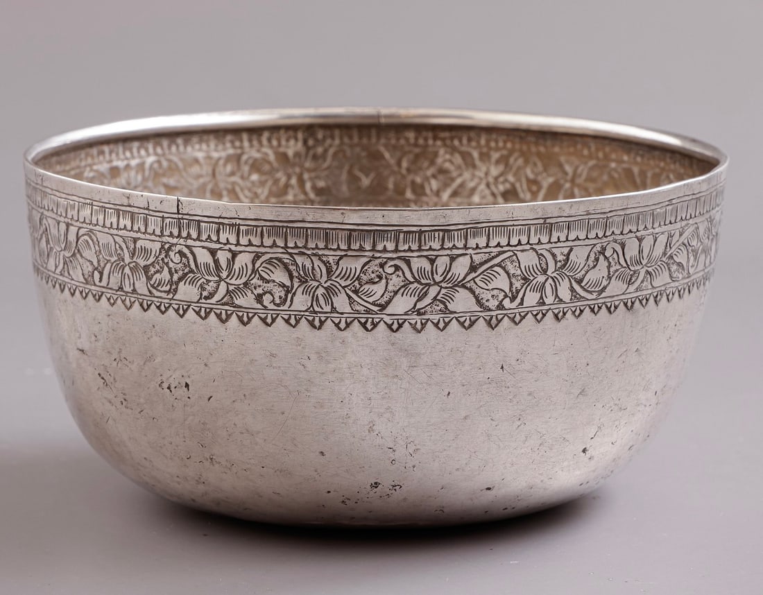 Tibetan Silver Bowl: Tibetan silver bowl, decorated with floral motifs. Height: 7 cm. Diameter: 14 cm. Weight: 196 grams. Unsigned, silver tested.