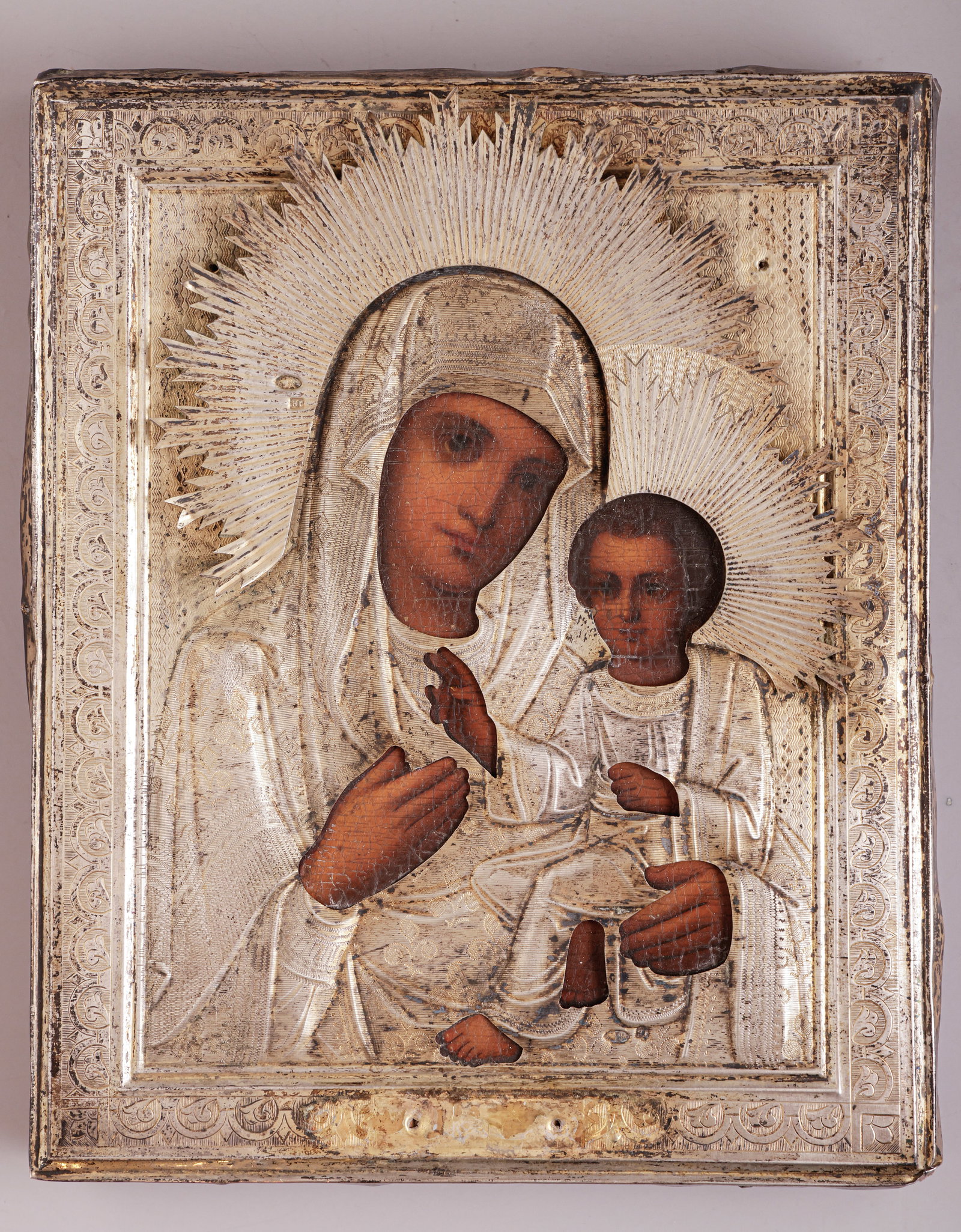 Christian Orthodox Silver Icon: Fine Russian orthodox icon depicting Mary and baby Jesus, ca. 1900. Made of wood and silver. Faces and hand are hand-painted in oil on the wooden board. Dimensions: 18X14.5 cm. Silver hallmarked.
