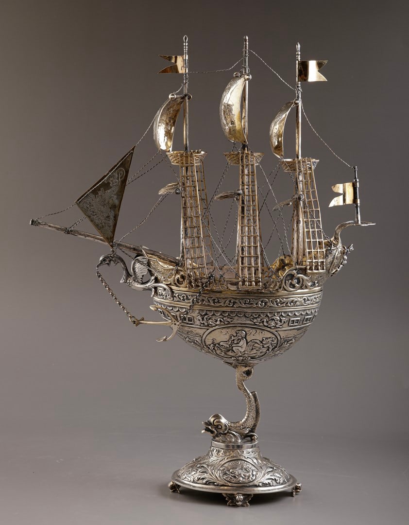 Silver Nef Sailing Vessel: Fine sterling silver Nef sailing vessel, probably German (produced for export to the United States). Constructed in two parts, with a dolphin-form stem. The body and sails are decorated with embossed