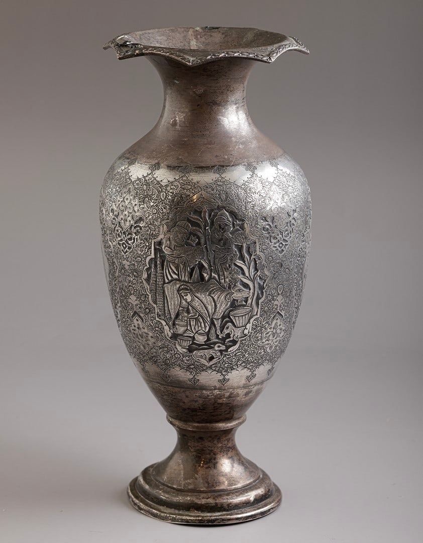 Persian Silver Jug: Persian silver jug, embossed and engraved with figures and floral motifs. Height: 25 cm. Weight: 532 grams. Hallmarked. Flaws.