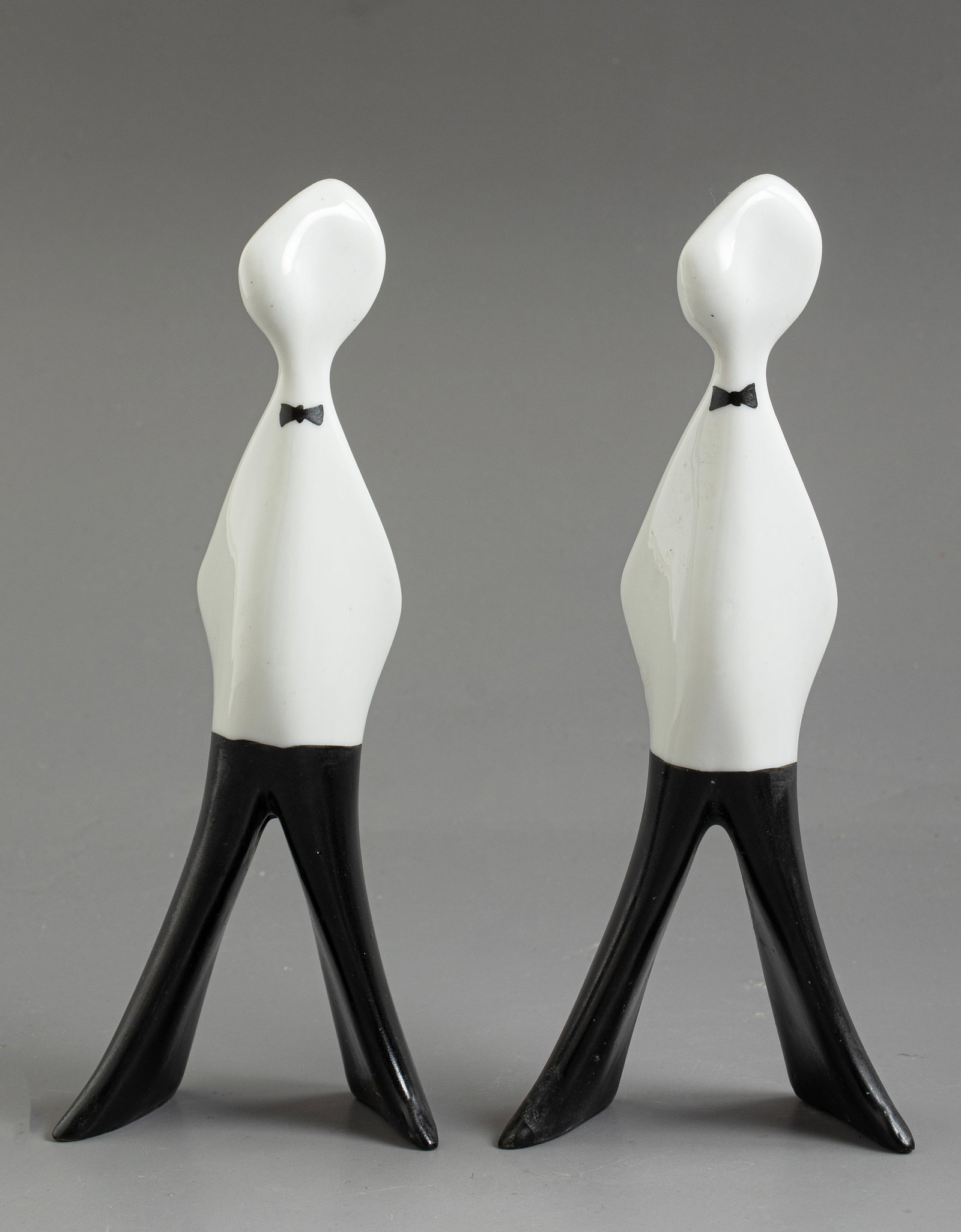 Cmielow Poland Porcelain Figurines: Pair of Polish porcelain figurines by ?mielów, designed by Lubomir Tomaszewski, circa 1960. Depicting waiters from the “Felek – Kelner” series. Height: 16 cm. Signed.