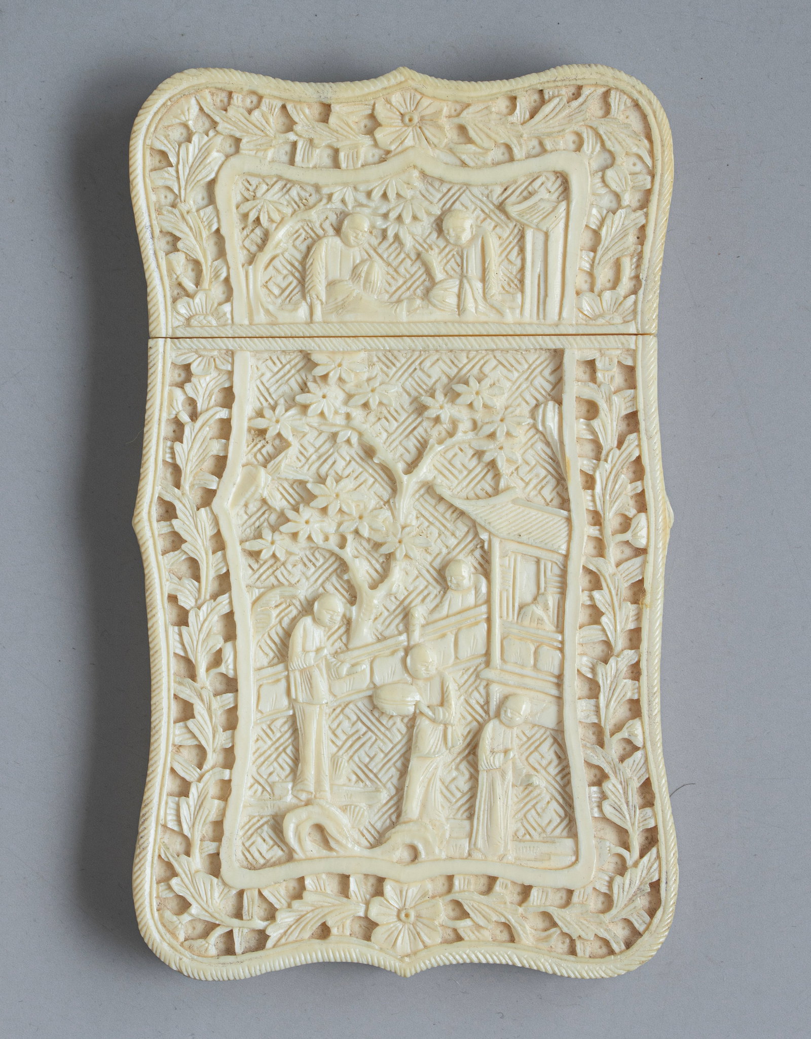 Carved Chinese Visiting Card Case: Chinese visiting card case, carved with scenes depicting figures, buildings, and floral motifs. Housed in a box. Dimensions: 19.5X1X5.5 cm.