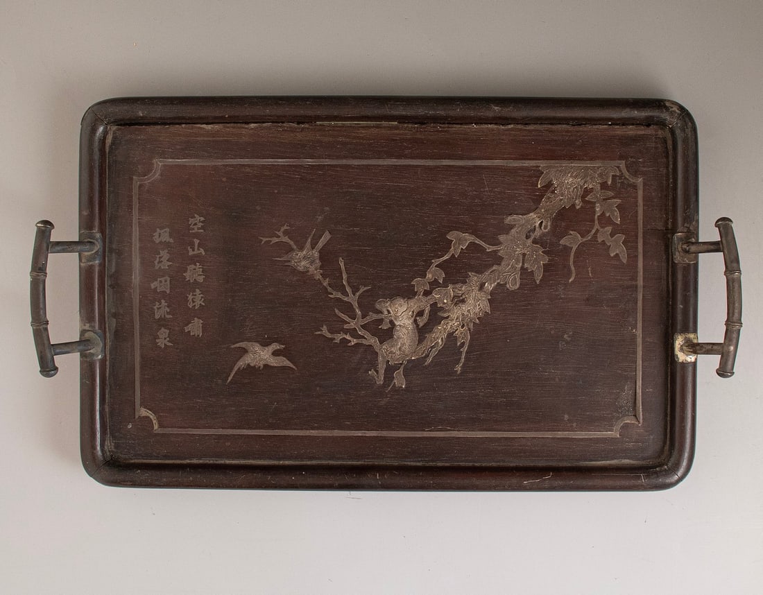 Chinese Wooden Tea Tray: Chinese wooden tea tray, inlaid with silver. Depicting gilt animals, floral and calligraphic motifs. With two handles. Dimensions: 25.5X40 cm. Minor flaws, a minor missing part.