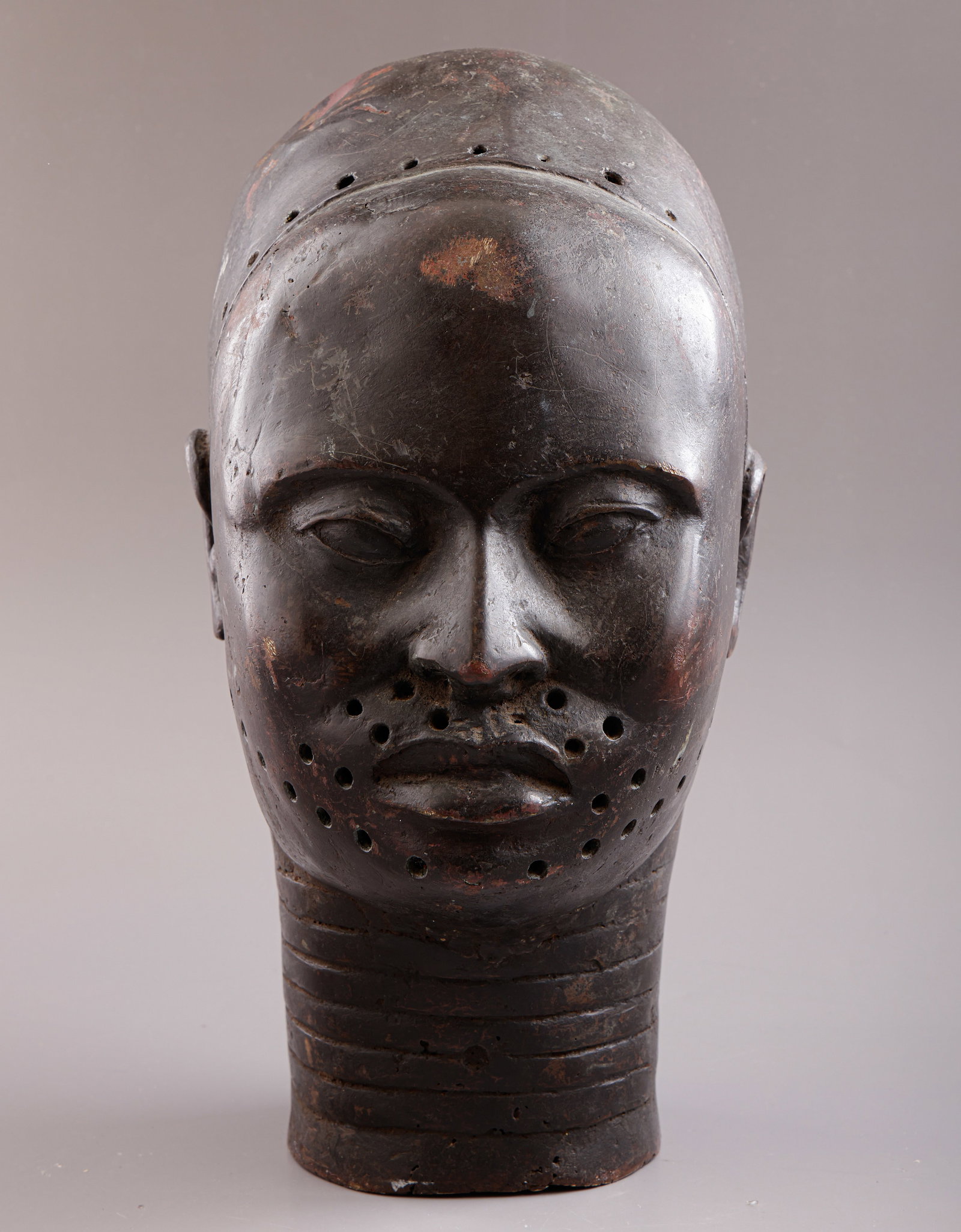 African Copper Sculpture: African copper sculpture, Yoruba people, Nigeria. In the form of an Ife head. Height: 31 cm. Dents.
