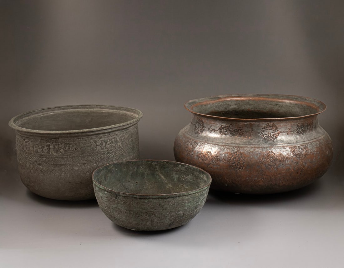 Persian Bowls: Lot of 3 Persian bowls, made of tinned copper. Decorated with floral motifs, some also with calligraphic decoration. Height: 8.5–18 cm. Max. diameter: 22–32 cm. Various conditions, flaws