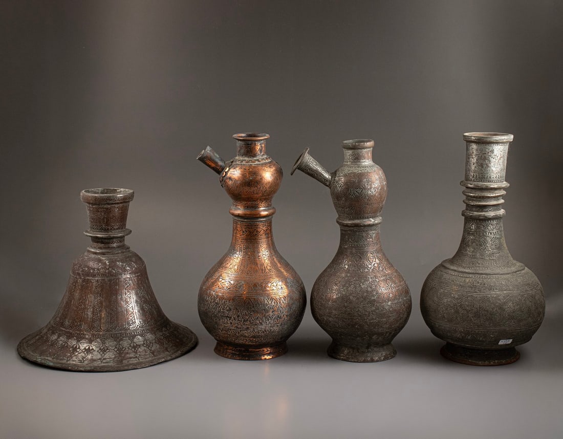 Persian Hookah Bases: Lot of 4 Persian hookah bases, made of tinned copper, 19th century. Decorated with floral motifs. Height: 20–29 cm. Minor flaws to some, wear to the plating on some.