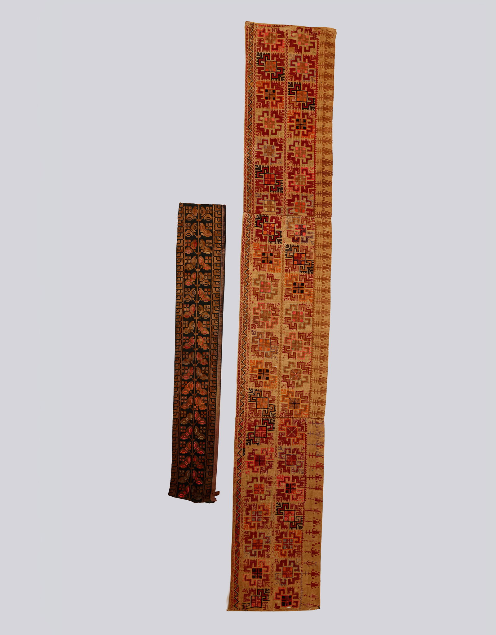 Palestinian Embroidery: Pair of textiles decorated with Palestinian hand embroidery, featuring geometric patterns and floral motifs. Dimensions: 130X20–64X11 cm.