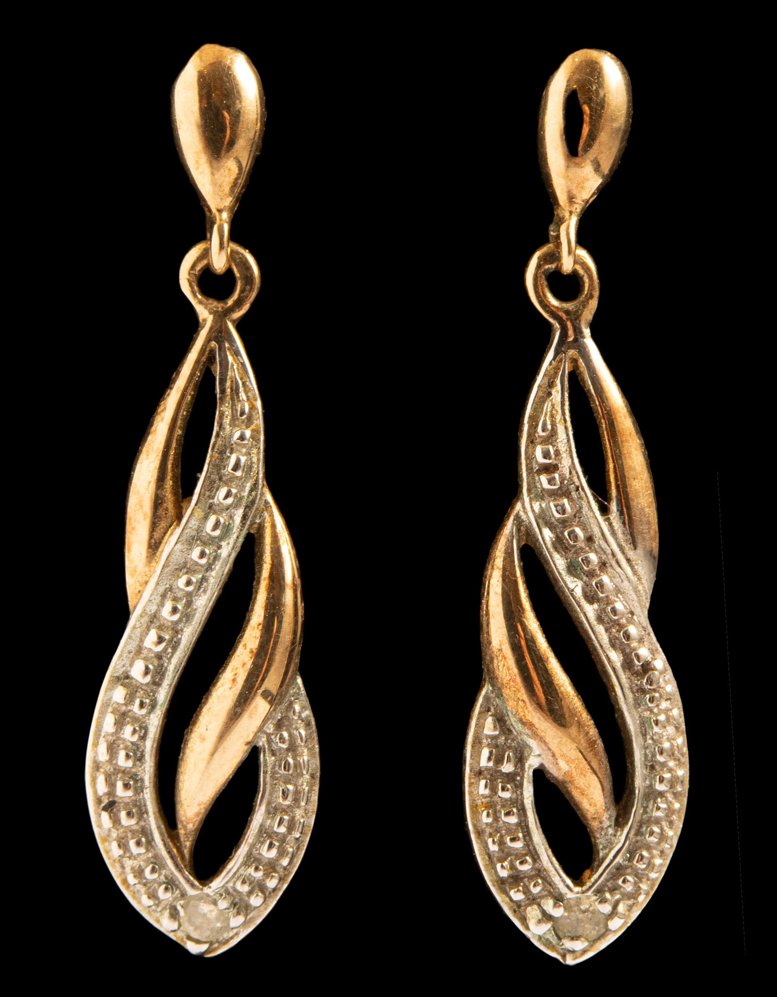 Gold Diamond Earrings: Pair of 9K gold earrings set with a diamond weighing about 1 point. Length: 17 mm, Total weight: 1.5 grams. Hallmarked.