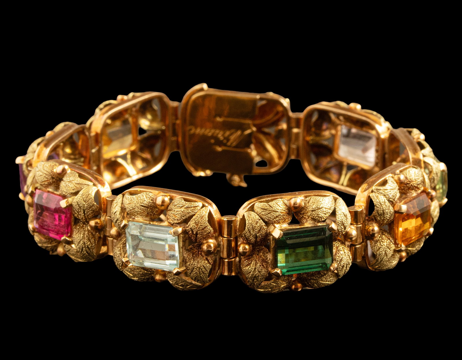 Gold Bracelet: 18K gold link bracelet, set with various gemstones including emerald, amethyst, tourmaline, aquamarine and more. Length: 18 cm, Width: 14 mm. Weight: 41 g. Hallmarked.