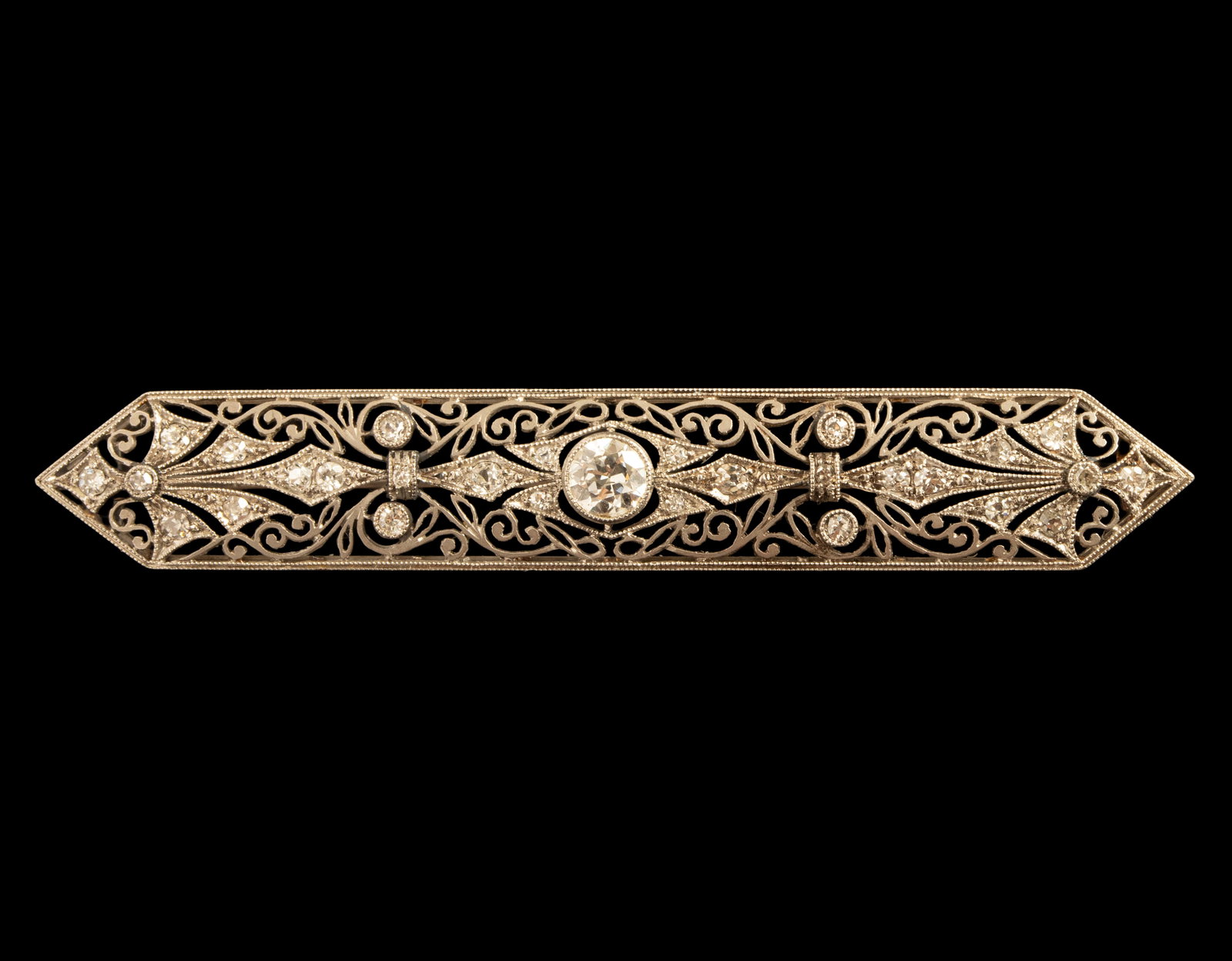 Art-Deco Platinum Diamond Brooch: Platinum brooch combined with 18K gold, Art Deco. Set with old-cut diamonds, including a center diamond weighing about 45 points and 28 diamonds weighing about 1-2 points each, for a total of about