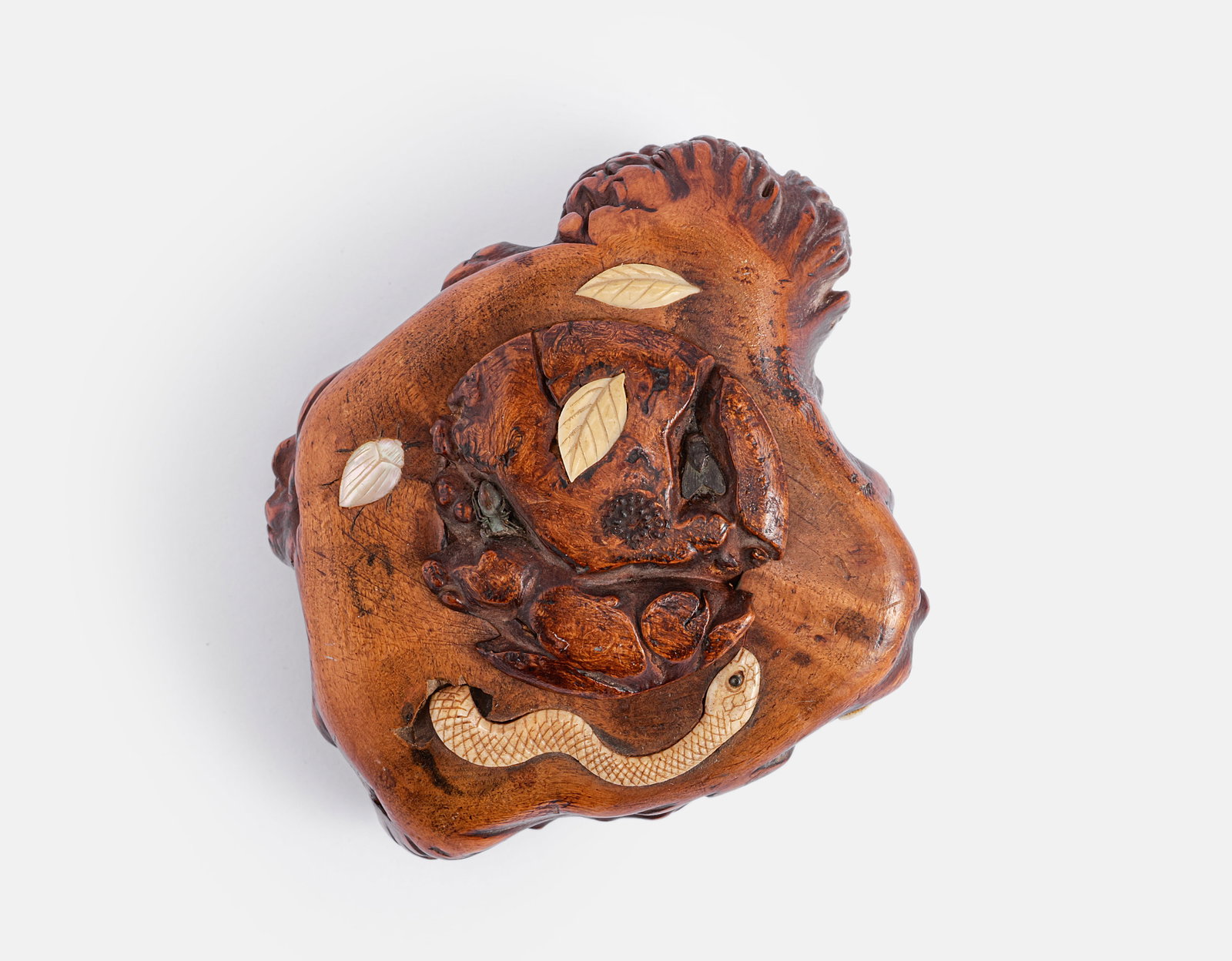 Japanese Wooden Inro: Japanese wooden inro, inlaid with a carving, mother of pearl and brass, depicting a snake and leaf patterns. Dimensions: 8X5X8.5 cm. Minor flaws.