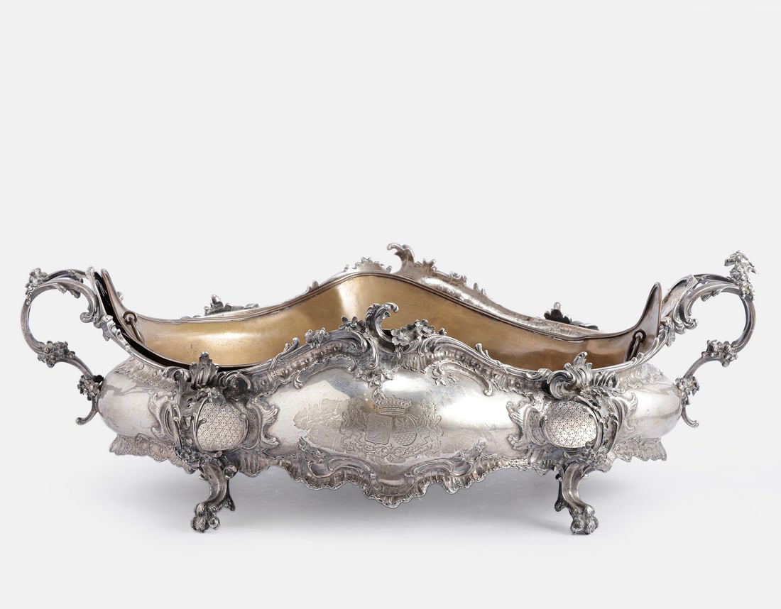Silver Centerpiece: Silver centerpiece, Central/Western Europe, late 19th century - early 20th century. Decorated with reliefs of floral motifs and engraved with an armorial crest. With a removable brass liner. Stands on