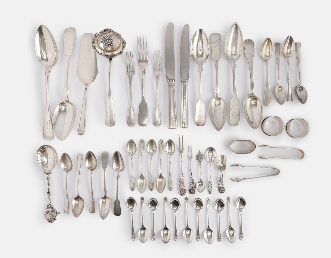 Silver Cutlery, Various Origins: Lot of 800 silver cutlery, various origins including Germany, Austria, the Netherlands and others. Including large serving spoons, teaspoons, napkin rings, a tea strainer, and two knives. Weight witho