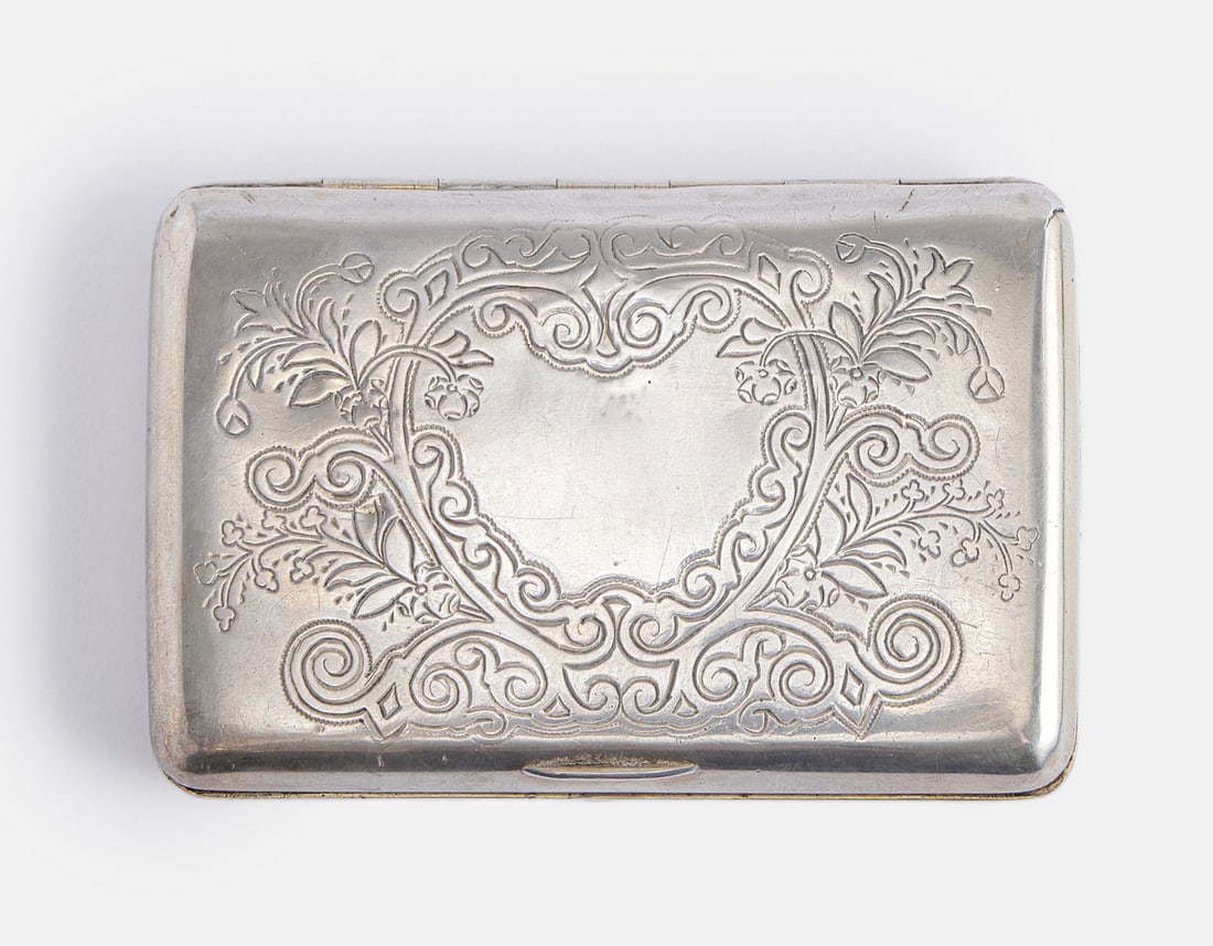 Russian Silver Cigarette Case: Russian 84 silver cigarette case by Anna Akimovna Stolyarova, Moscow, circa 1890. Engraved with floral motifs, in the form of a heart. Gilt interior. Dimensions: 9.5X6.5 cm. Weight: 107 grams. Minor