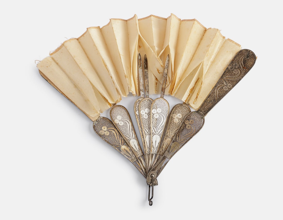 Silver & Silk Fan: Silver and silk fan, decorated with filigree work. Length: 21.5 cm. Total weight: 95 grams. Unsigned, silver tested. Flaws.