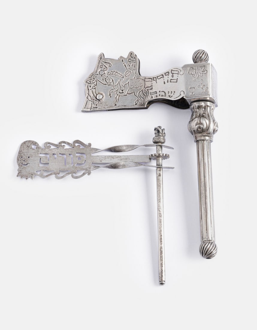 Silver Purim Graggers: Lot of 2 sterling silver Purim graggers. One decorated with engravings depicting Mordechai riding a horse and Hebrew inscriptions, the other decorated with openwork and a Hebrew inscription