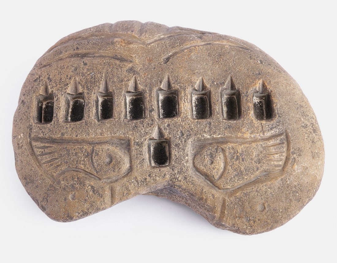 Yemenite Stone Hanukkah Lamp: Yemenite stone Hanukkah lamp. Decorated with fish patterns. Dimensions: 13X19 cm.