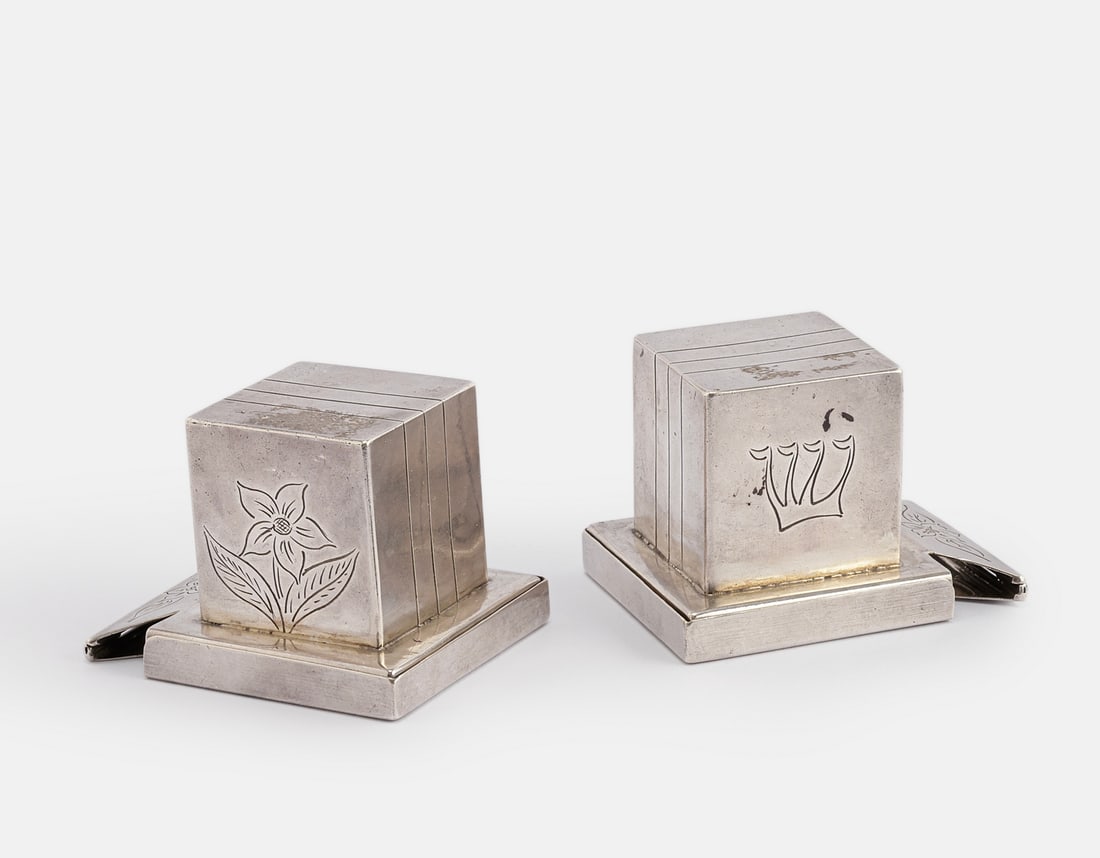 Silver Tefillin Cases Pair, Poland: Pair of mid 19th century Polish 12 silver Tefillin cases (for head and hand). Decorated with engraving of floral motifs and a Hebrew letter. Height: 5.5 cm. Length: 7 cm. Total weight: 216 grams.