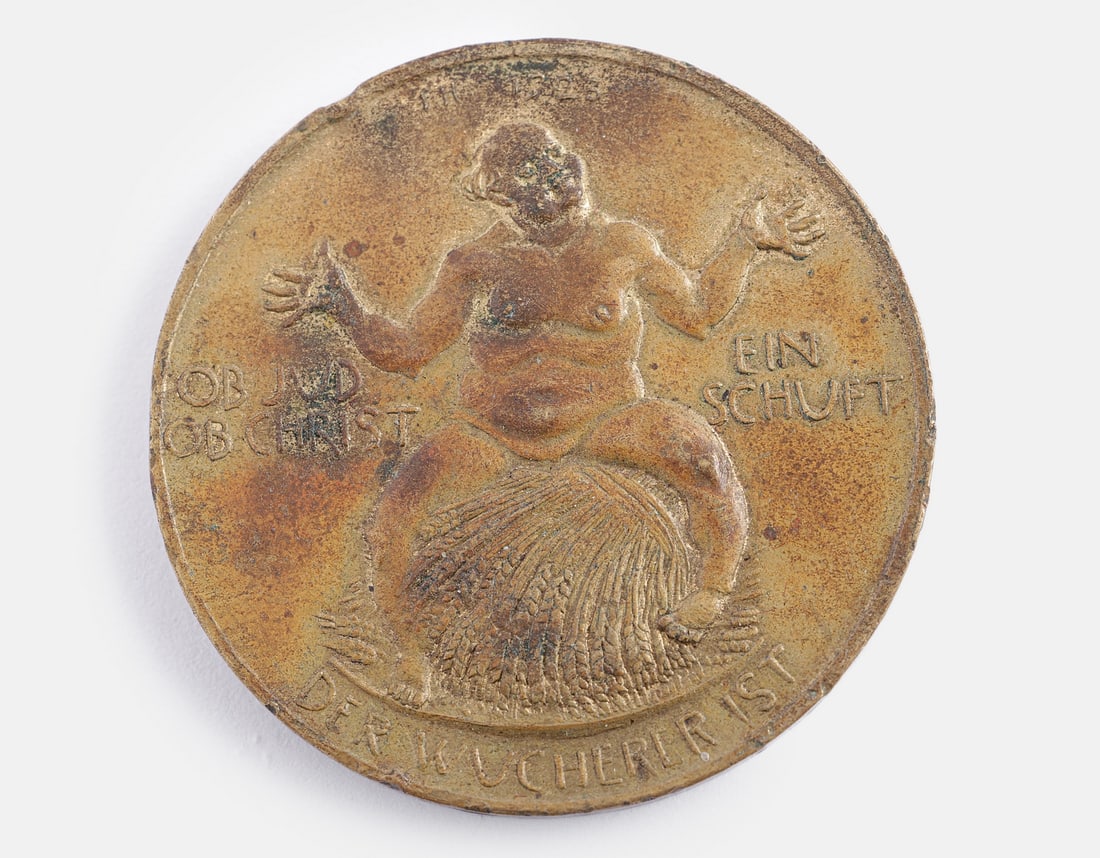 German Antisemitic Bronze Medal: German antisemitic bronze medal, 1923. Obverse: depicting a Jew seated on a pile of sheaves, with the inscription: "Ob Jud ob Christ, ein Schuft der Wucherer ist" ("Whether Jew or Christian, a usurer