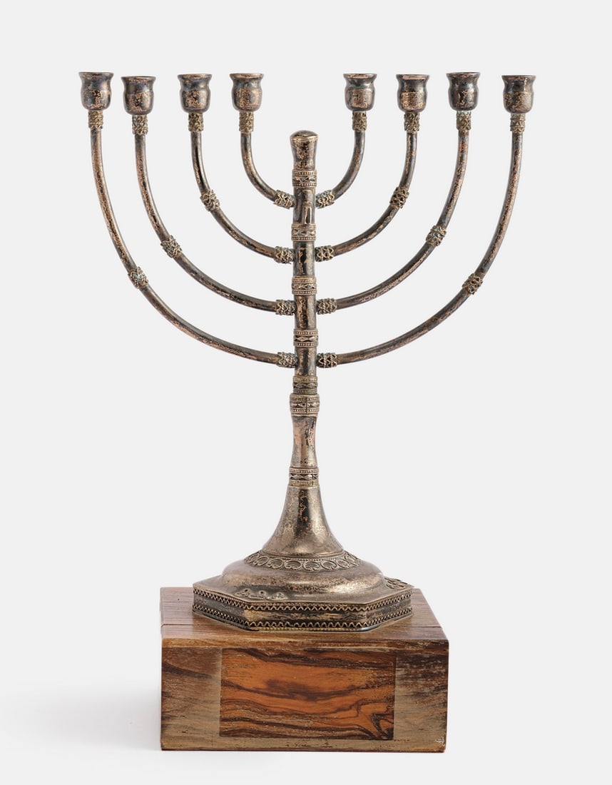 Silver Hanukkah Menorah, Bezalel Style: Silver Hanukkah Menorah, Bezalel style. Decorated with filigree work. Attached to an olive wood base. Height (including the base): 24 cm. Total weight: 418 grams. Unsigned, silver tested. Missing