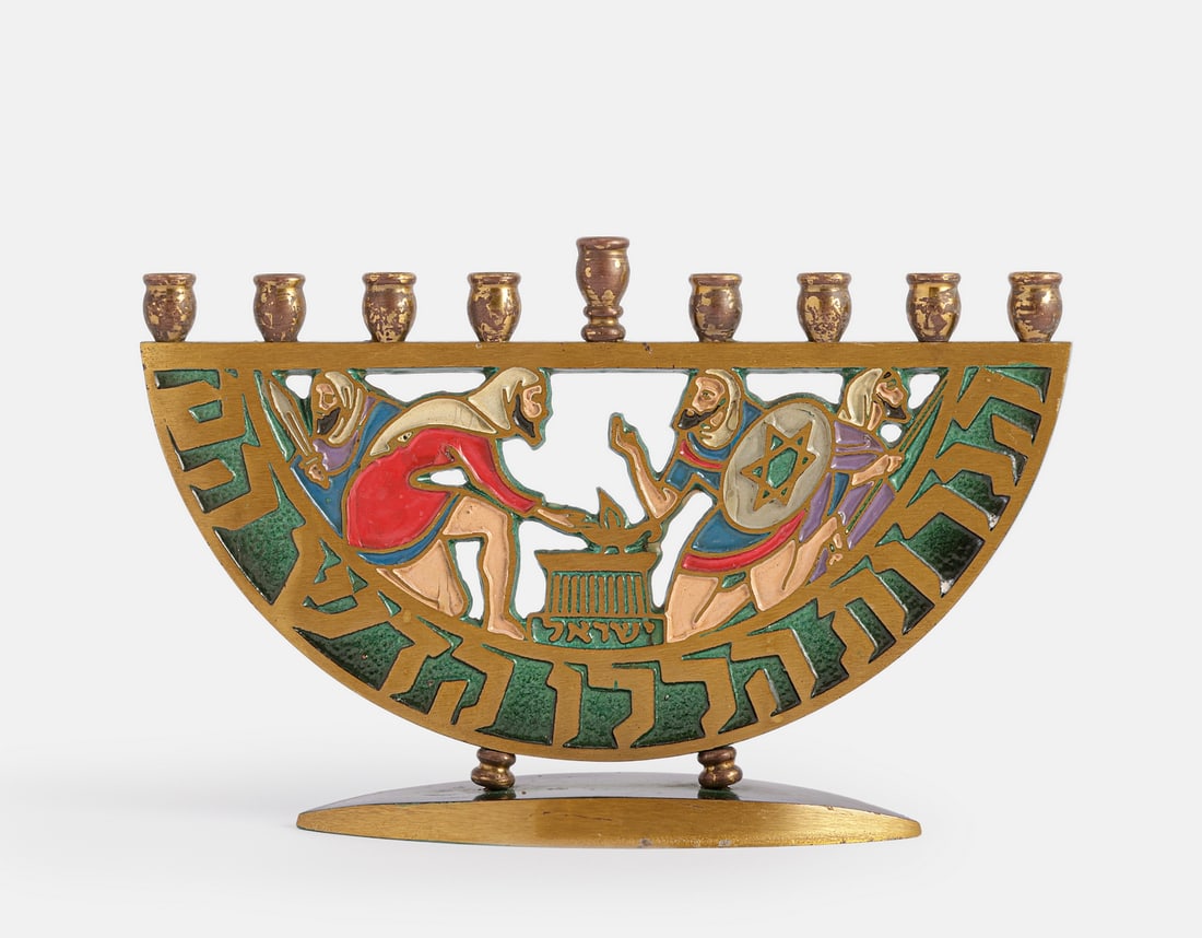 Dayagi Israel Hanukkah Lamp: An Israeli brass Hanukkah Menorah by Dayagi, decorated with Maccabee figures lighting an oil lamp. Width: 20 cm. Marked.