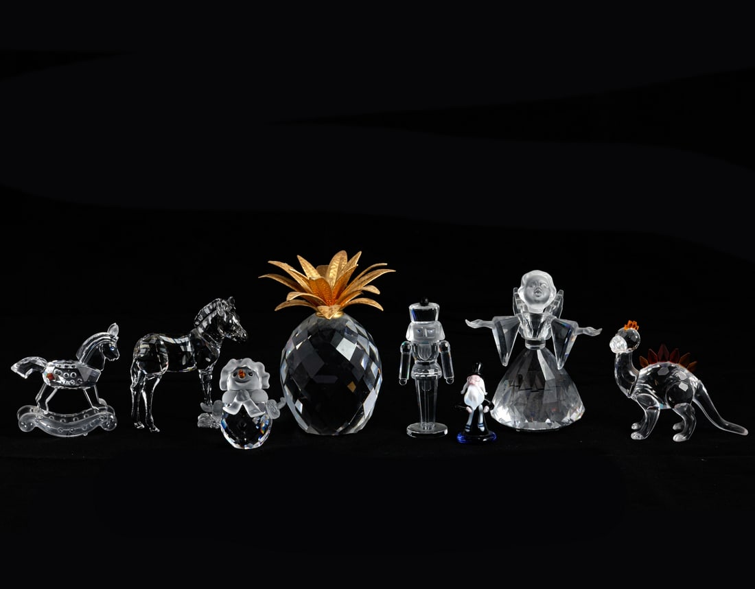 Swarovski Crystal Figurines: Lot of 8 Swarovski crystal figurines, shaped as figures, animals, and a pineapple. Height: 3-10 cm. Signed. In their original boxes, some of the foam inserts are worn.