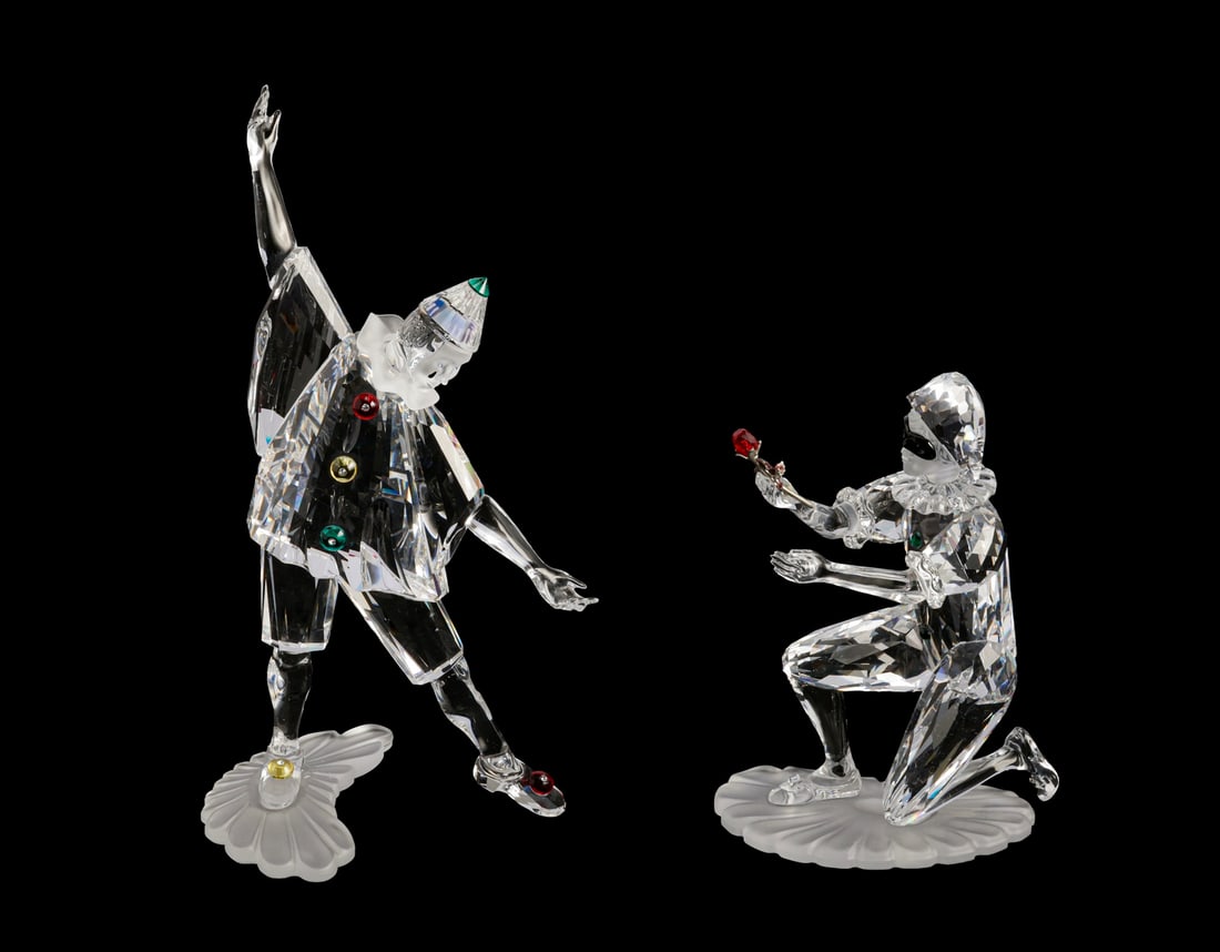 Swarovski Crystal Figurines: Lot of 2 Swarovski crystal figurines, shaped as Harlequin and Pierrot. Height: 13-20 cm. Signed. In their original boxes, some of the foam inserts are worn.