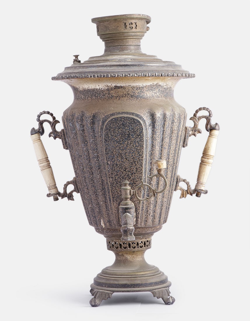 Russian Samovar: Large Russian silver plated brass samovar, with carved handles. Height: 55 cm. Marked. Wear to the plating, minor flaws.