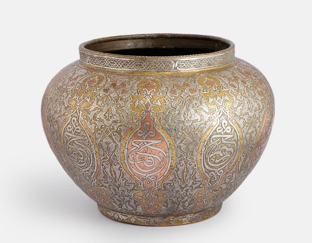 Large Damascene Brass Bowl: Large and fine Islamic brass bowl, inlaid with silver and copper (Damascene). Decorated with floral and calligraphic motifs. Height: 30 cm. Max. diameter: 39 cm.