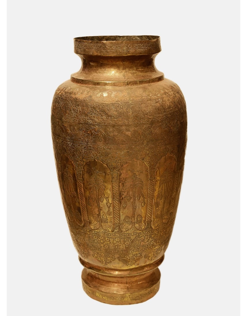 Large Syrian Copper Vase: Large Islamic copper vase, probably Syrian, engraved with scenes of figures riding camels, palm trees, birds, deer, lions, and floral motifs. Height: 78 cm. Max. diameter: approx. 42 cm.