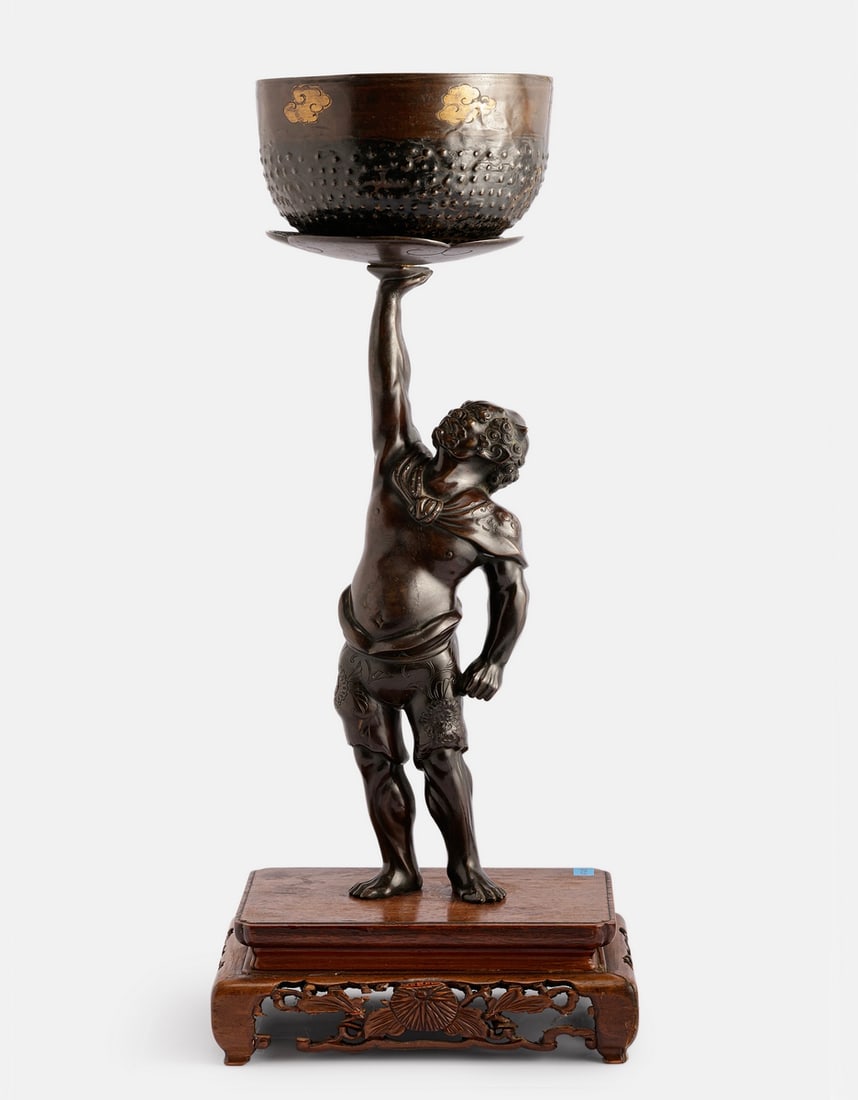 Japanese Bronze Sculpture, Meiji Period: Japanese bronze sculpture, Meiji period. In the form of an Oni demon. Attached to a carved wooden base decorated with floral motifs. Height (including the base): 42 cm. Minor flaws to the wooden base.