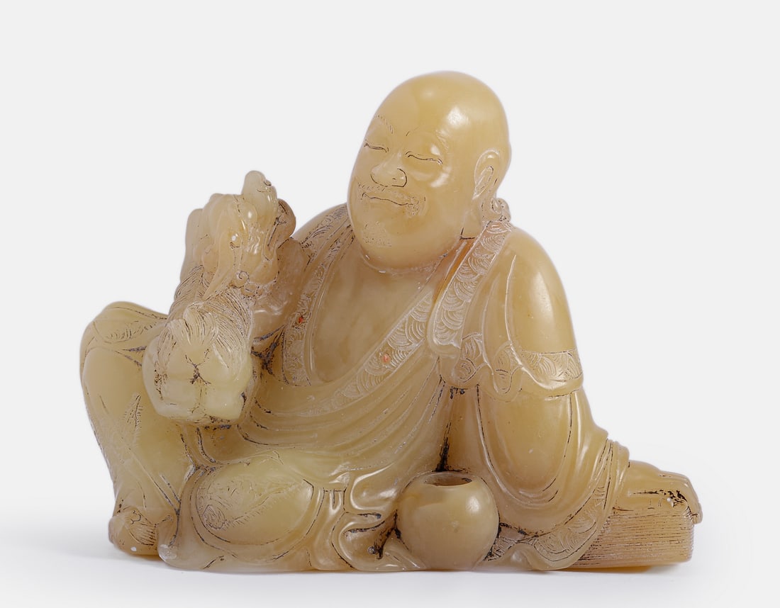 Chinese Shoushan Soapstone Sculpture: Fine Chinese Shoushan soapstone figurine, late Qing dynasty. Carved in the form of a Luohan accompanied by a Foo dog. Height: 7 cm.