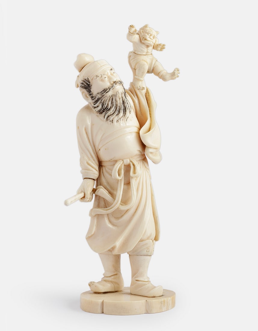 Carved Japanese Okimono: Fine Japanese okimono, carved depicting a samurai holding a demon. Height: 18.5 cm. Signed. Missing one toe, minute cracks.