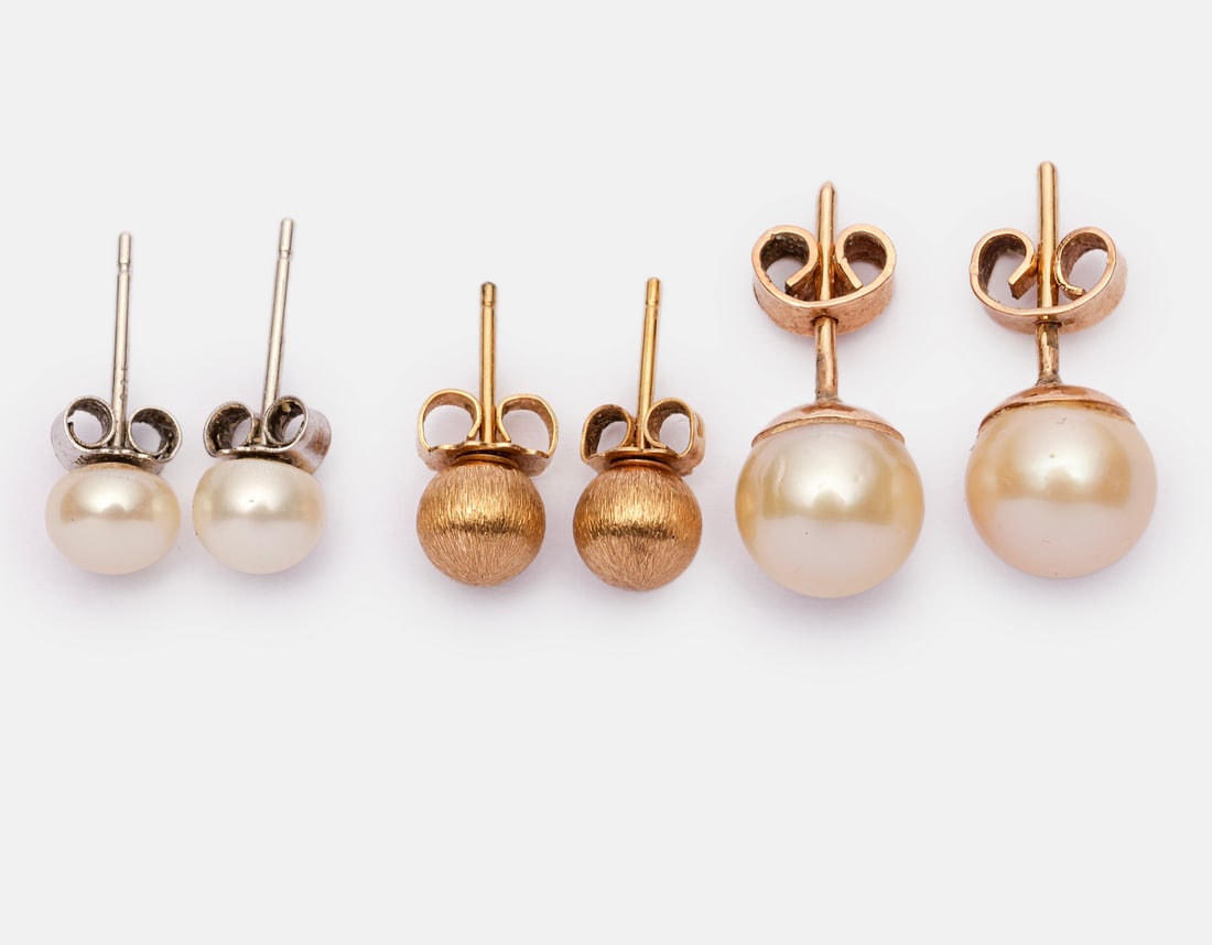Gold & Pearl Earrings: Two pairs of 14K gold stud earrings, one set with a pearl. In addition, a pair of silver earrings set with pearl. Total weight of the gold earrings: 3 grams. Some hallmarked, gold tested.
