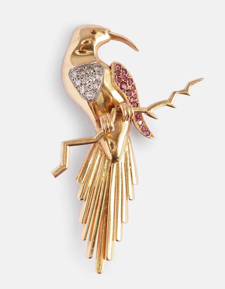 Gold, Ruby & Diamond Brooch: 18K gold brooch shaped as a bird, set with 14 rubies and 12 diamonds weighing about 2 points each. Length: 70 mm. Weight: 16.1 g. Unmarked, gold tested.