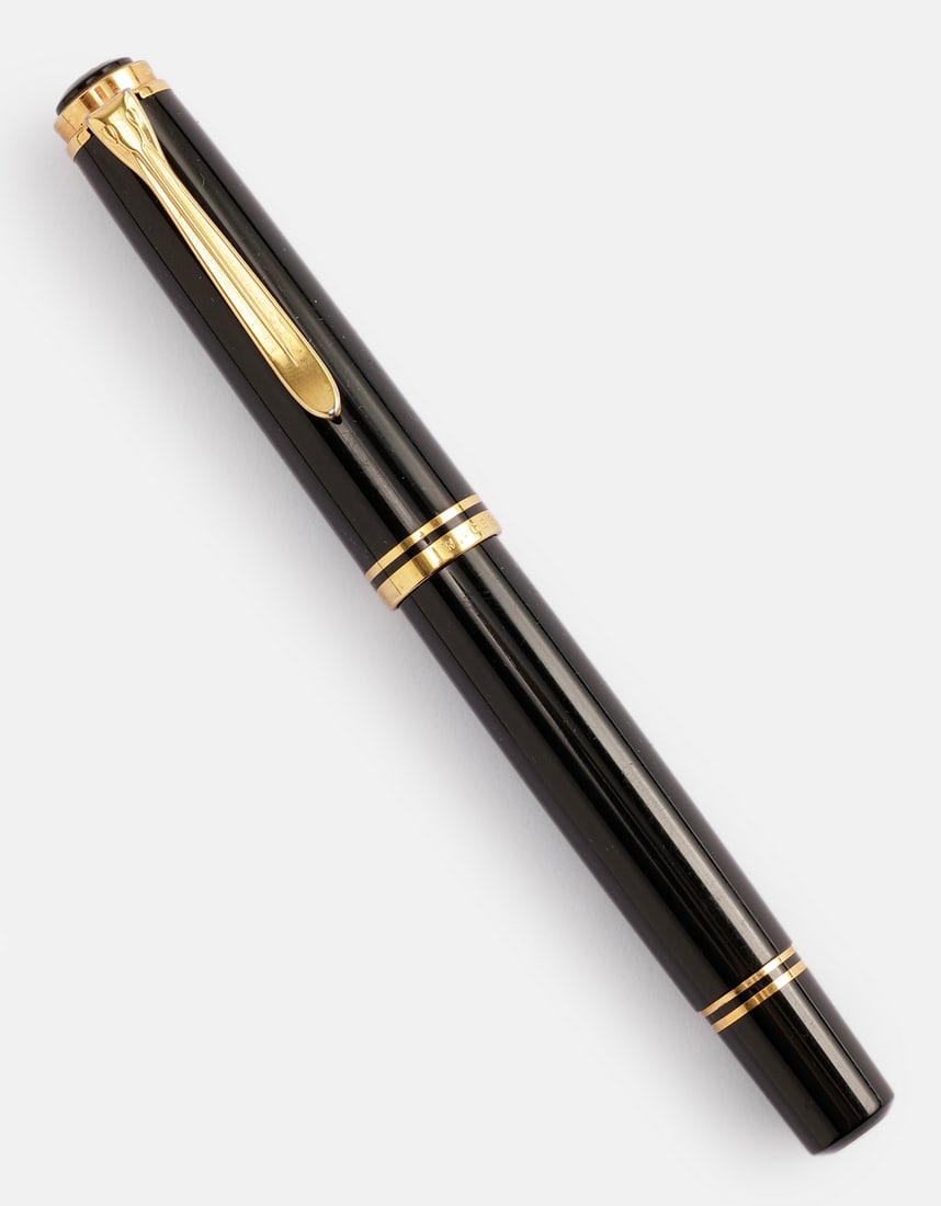 Pelikan M800 Fountain Pen: Pelikan M800 fountain pen, West Germany, Black with GP trims. Size: 5.55" (14.1 cm). 2 toned 18K gold nib, B. Excellent condition.