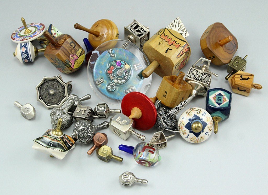 Large collection of dreidels: A large collection of dreidels including silver dreidels (some with filigree work, weight of the silver dreidels over 100 grams), wooden dreidels, porcelain dreidels and more.
