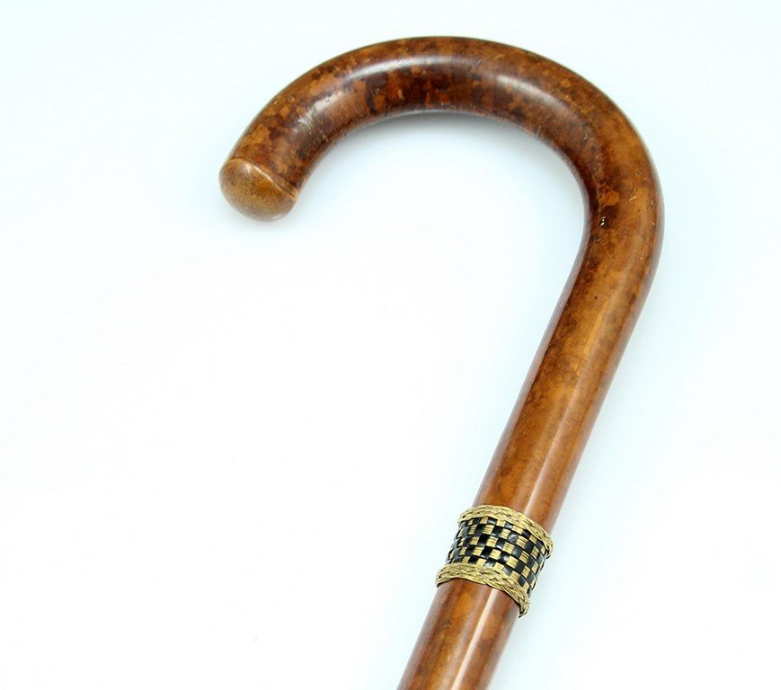 A wooden cane: A wooden cane, decorated with gilded copper strings ring. Length: 85 cm. Signed Dunhill London.