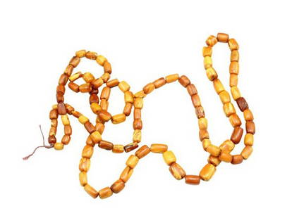 String of Ambers: A string of ambers. Length: 108 cm. Approx. length of each amber: 1 cm. Weight: 45 grams.