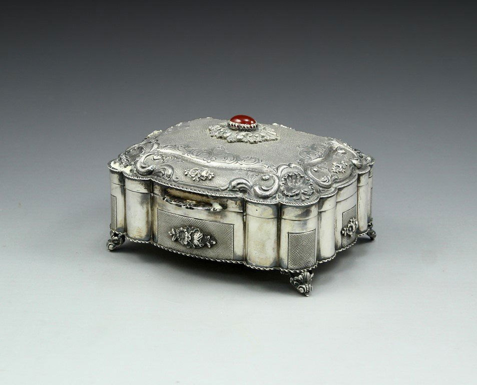 Silver Jewelry Box: An 800 silver Italian jewelry box. Decorated in Baroque style, with flowers and shells. Top with Agate cabochon and gilded interior. Measurements: 13X15X9 cm, weight: 511 grams. Hallmarked.