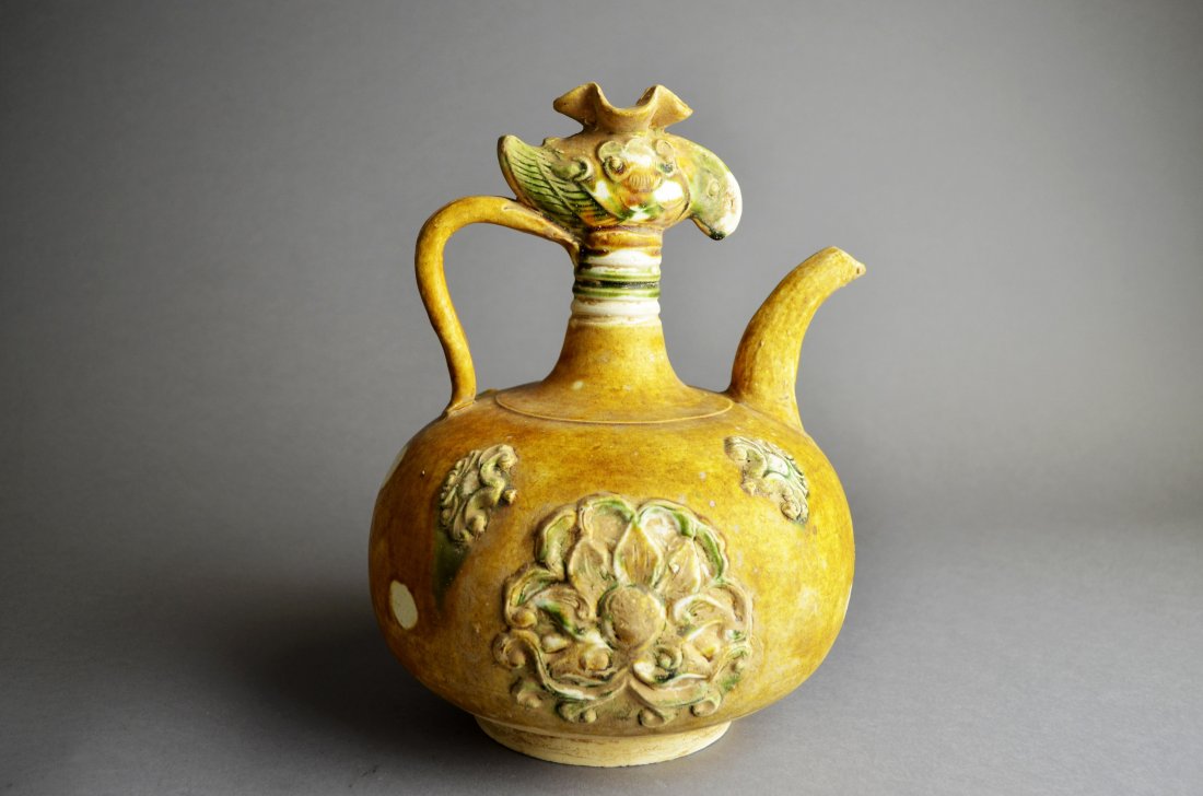 Chinese Tang Sancai Pottery Ewer: Possibly late 7th Century, phoenix-head earthenware in polychrome glaze, similar vessel located in The Metropolitan Museum of Art in New York, Robert Lehamn Collection. Good condition. ; 25 x 19cm ; 1