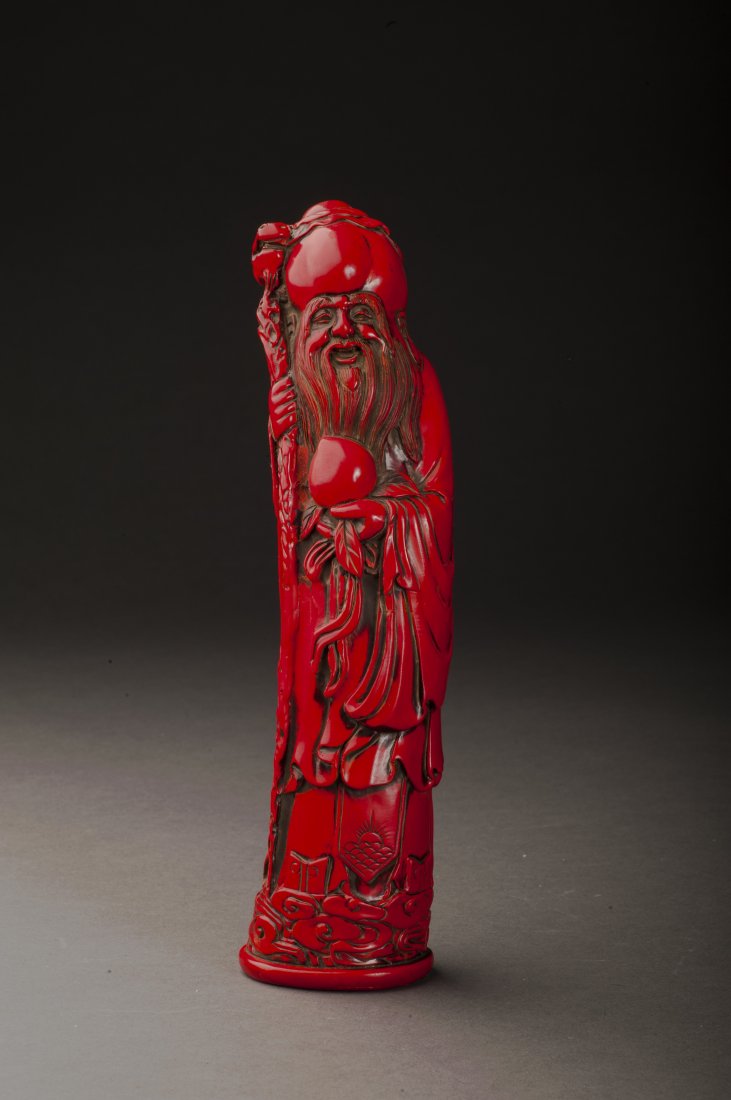 Lacquer Statue: A fine lacquer statue of the god of longevity , with a round peach holding in left hand. Face vividly expressed, dressed in nice lobe, carved in extremely detailed.