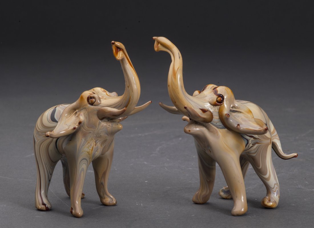 A pair of Old Glass Elephants: A pair of elephants, made from old glass, with special color.