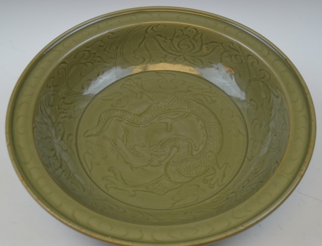 Chinese Celadon Glazed Charger: Ming Dynasty. Chinese celadon glazed longquan charger carved of dragon on the center of charger. 15" x4"