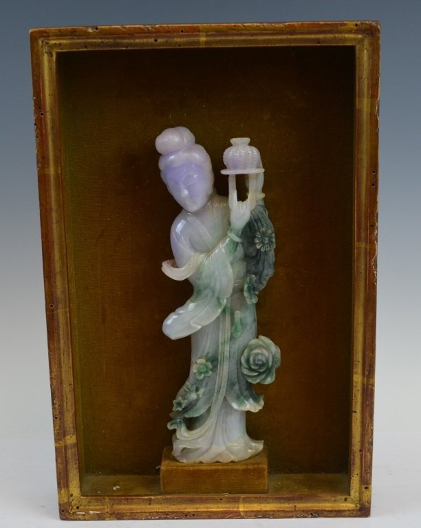 Chinese Multi-Colored Women Carved Jadeite: A framed jadeite carving of a woman. The woman is depicted carrying a lantern. The jadeite is purple near the head but slowly becomes green. There are flowers budding on her dress. The height of the j